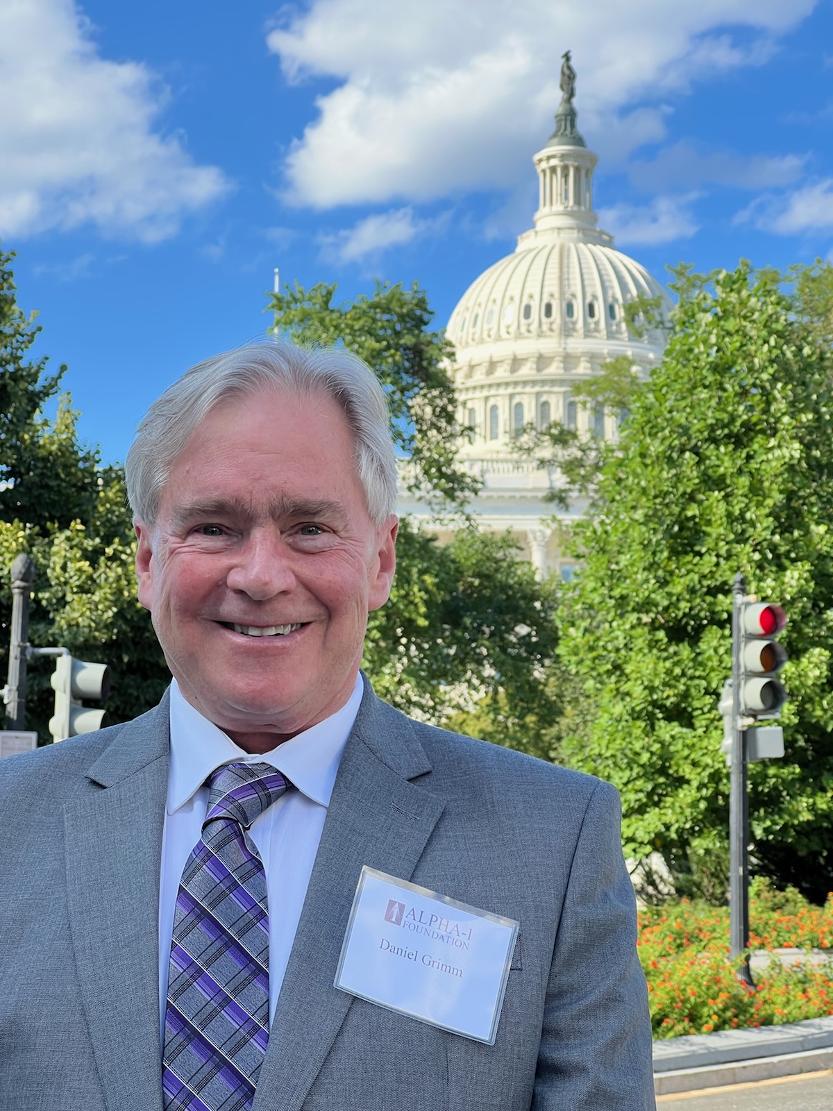 Daniel Grimm poses in front of the capital building